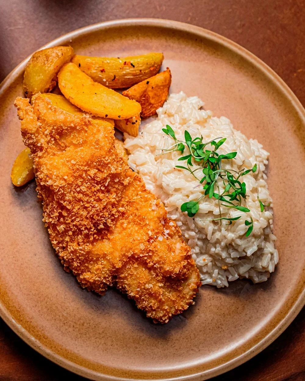 Panko-crusted chicken milanese with creamy lime rice and rustic potatoes